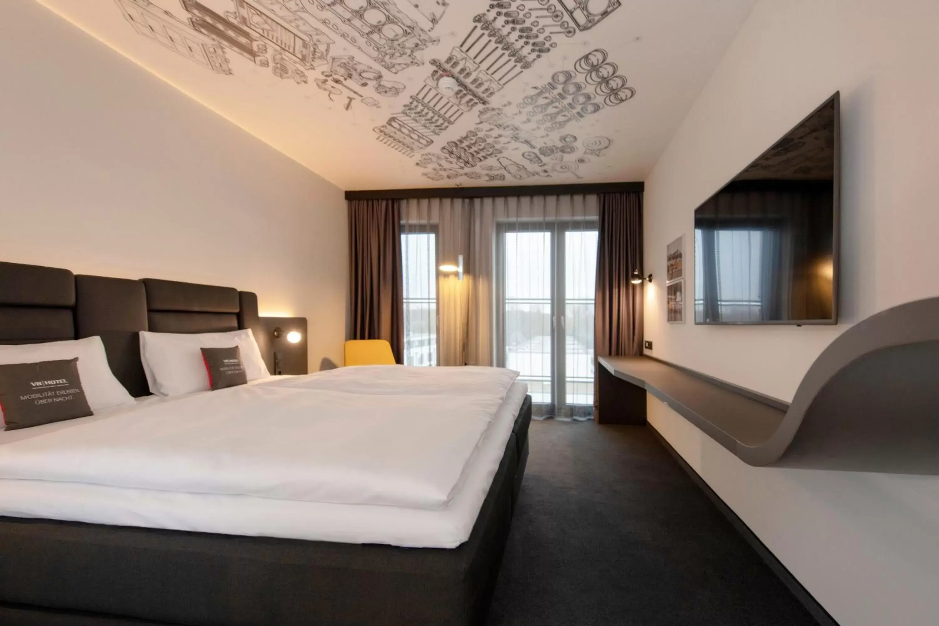 Photo of the whole room, Bed in V8 Hotel Köln at MOTORWORLD Photo of the whole room, Bed in V8 Hotel Köln at MOTORWORLD